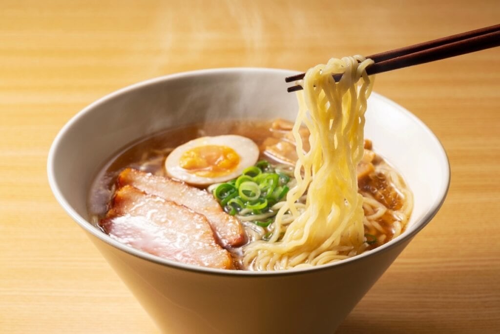 Ramen with a soft boiled egg in a bowl.