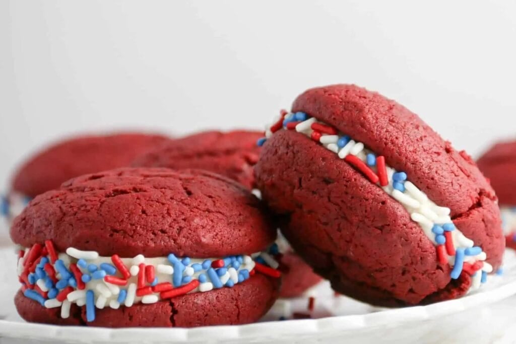 Red velvet sandwich cookies with sprinkles.