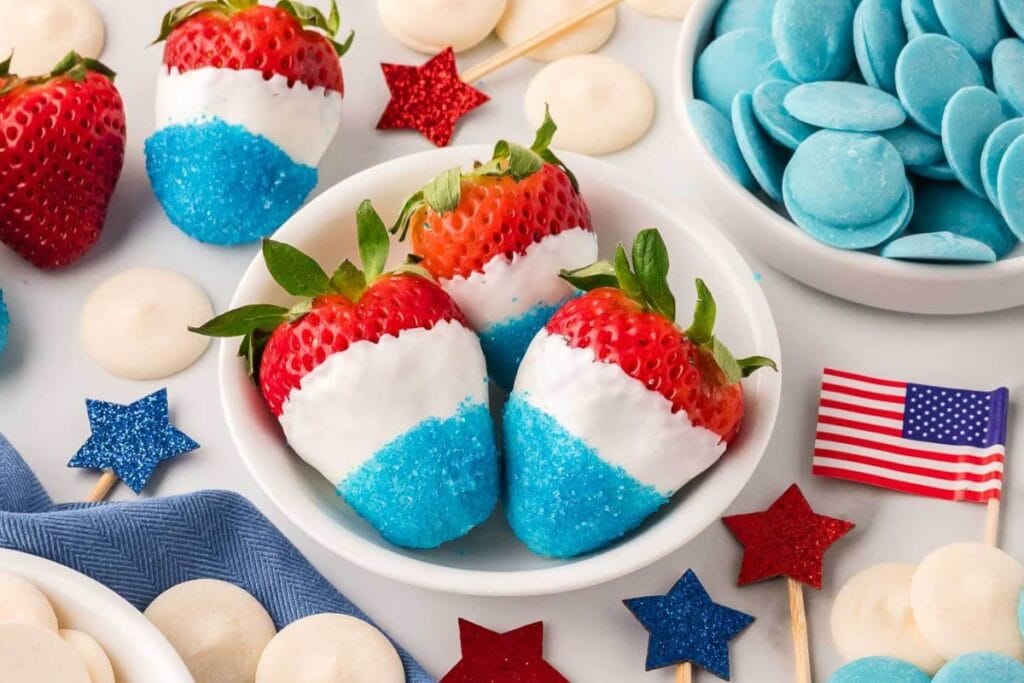 Red, white, and blue strawberries in a bowl.