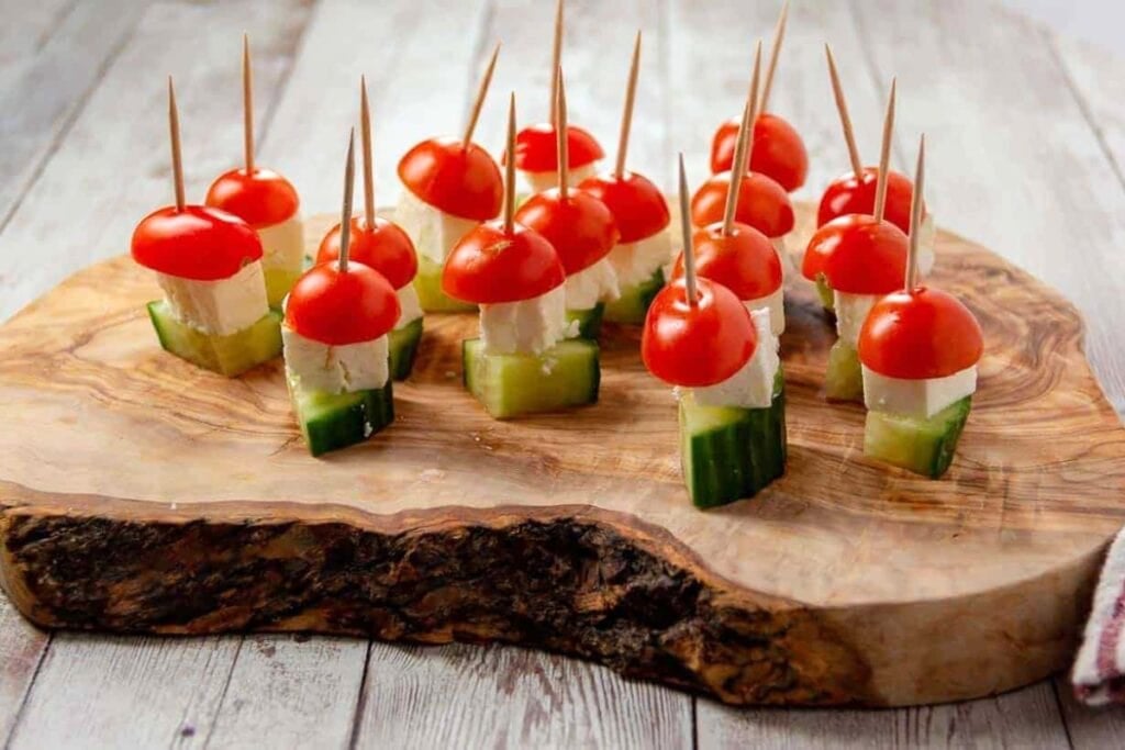 Salad skewers on a wooden board.