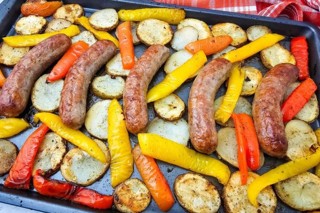 A close up shot of sheet pan sausage peppers and potatoes.