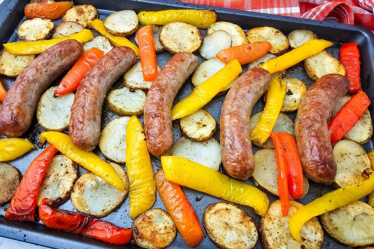 A close up shot of sheet pan sausage peppers and potatoes.