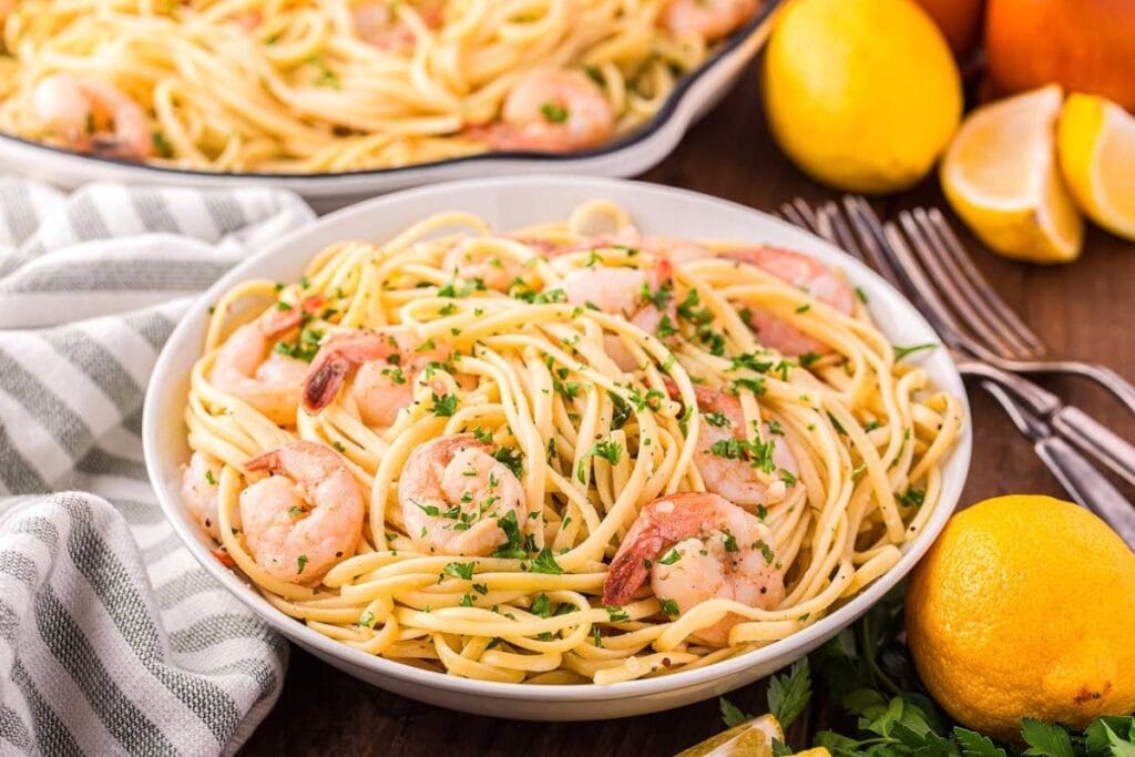 Shrimp linguine pasta with lemon and parsley on a plate.