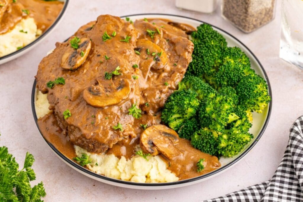 Slow cooker cube steak on a plate.