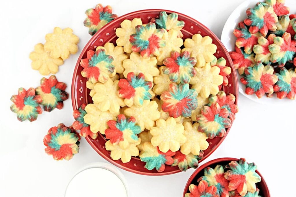 Colorful red, white, and blue spritz cookies in bowls.