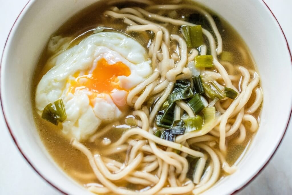Ramen noodles with poached egg in a bowl.