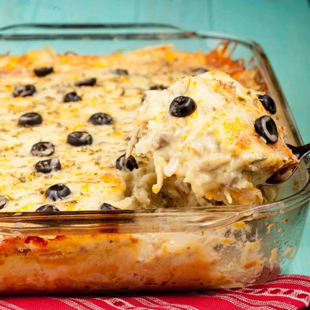 White chicken enchilada casserole in a baking dish.