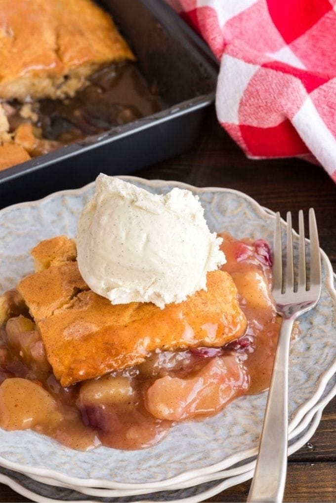 Apple cranberry crisp on a plate with a fork on the side.