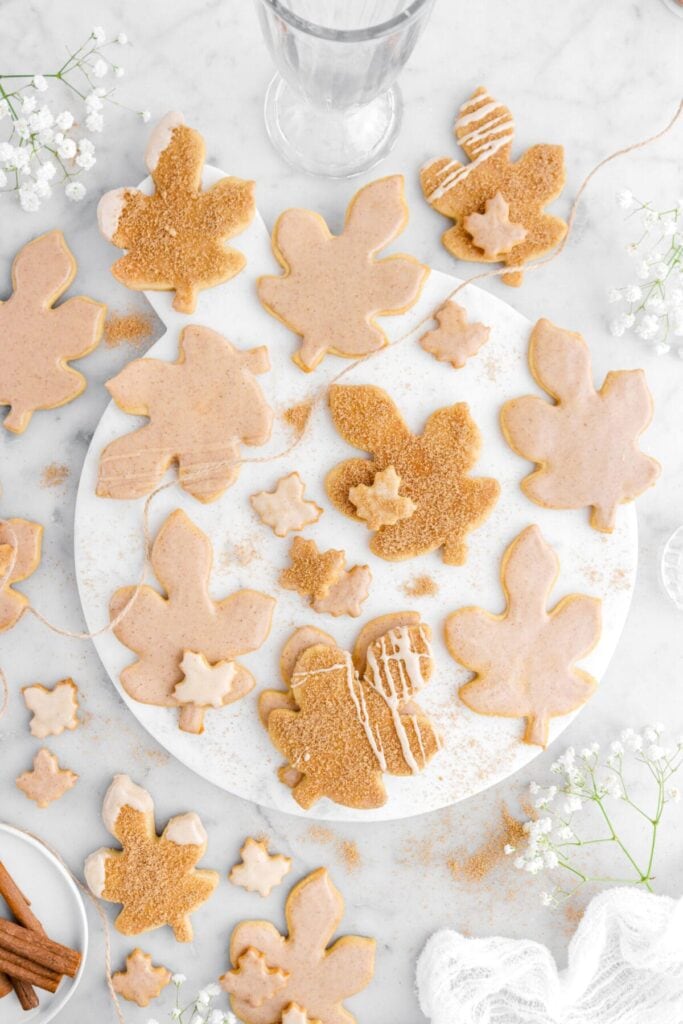Iced maple cutout sugar cookies on a plate.