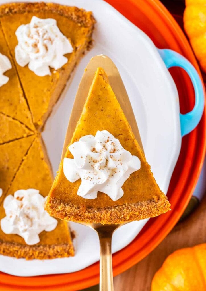 Pumpkin pie with graham cracker crust on a spatula.