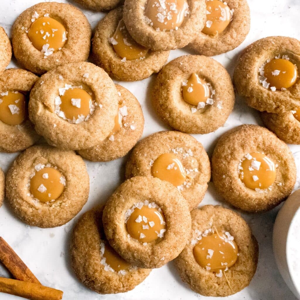 Salted caramel cinnamon thumbprints on a marble surface.