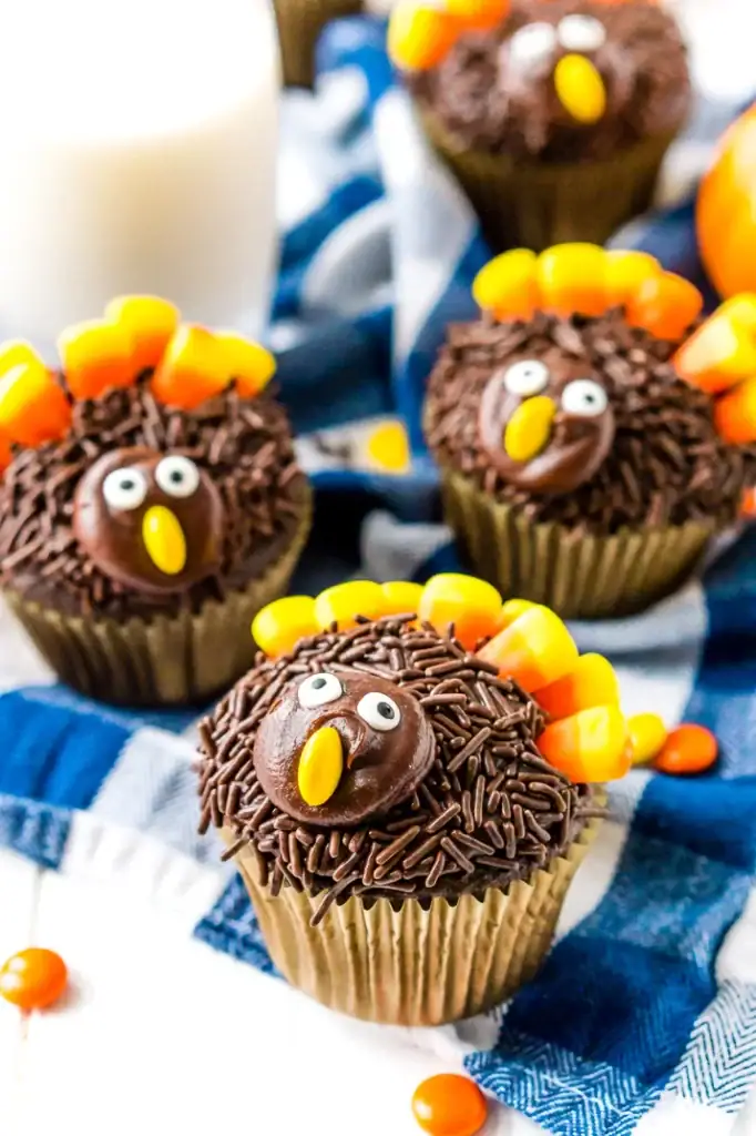 Close-up of turkey cupcakes with frosting and candy corn feathers.