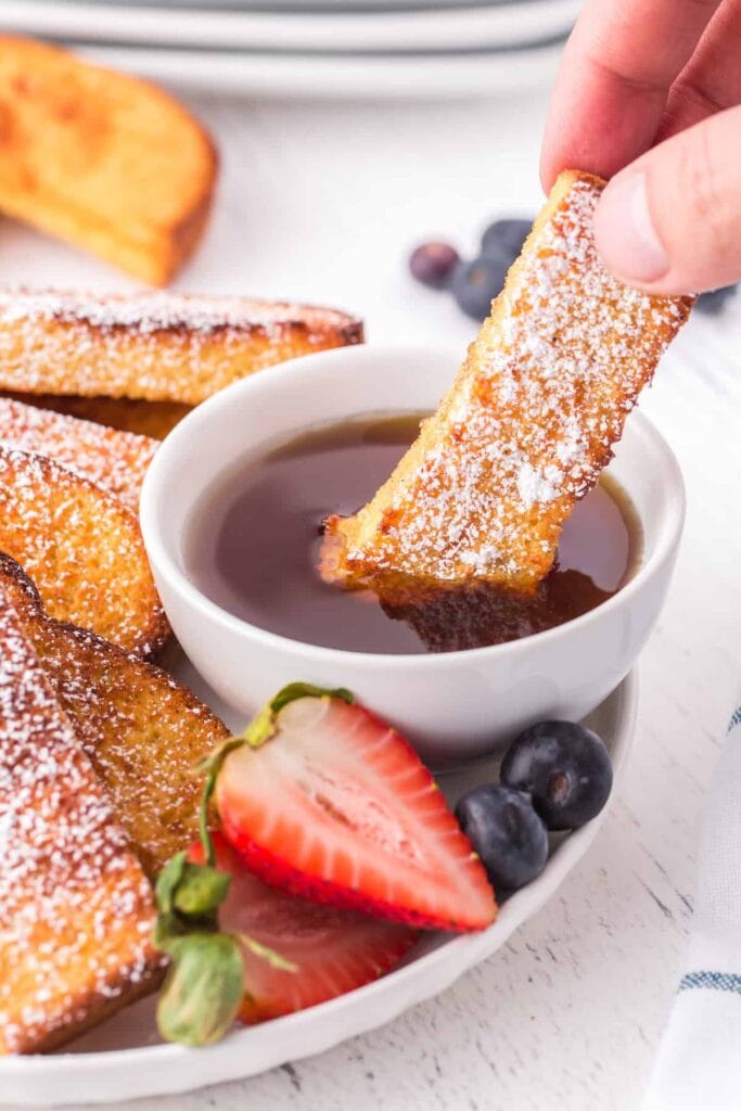 French toast being dunked in syrup