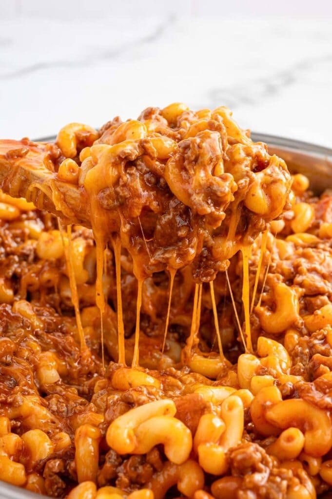 Close-up of bacon cheeseburger pasta on a spoon.