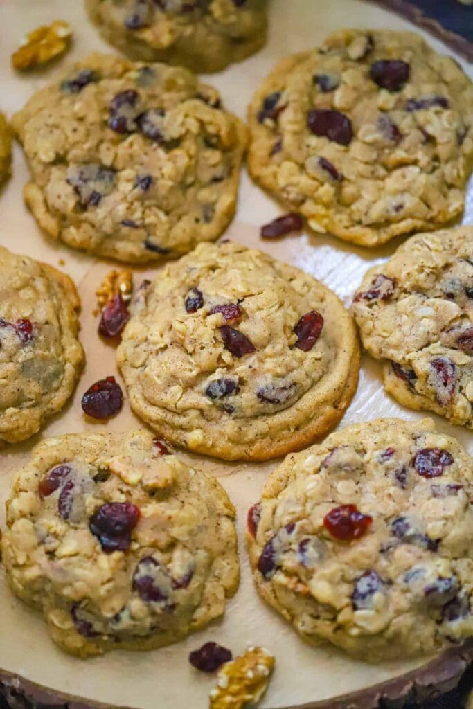 Brown butter cranberry walnut oatmeal cookies on parchment paper.