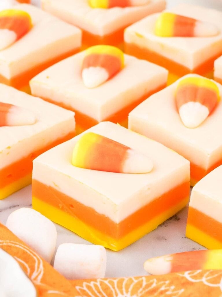 Candy corn fudge on a white surface.