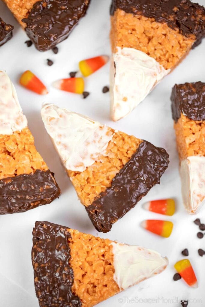 Candy corn Rice Krispie treats on a white surface.