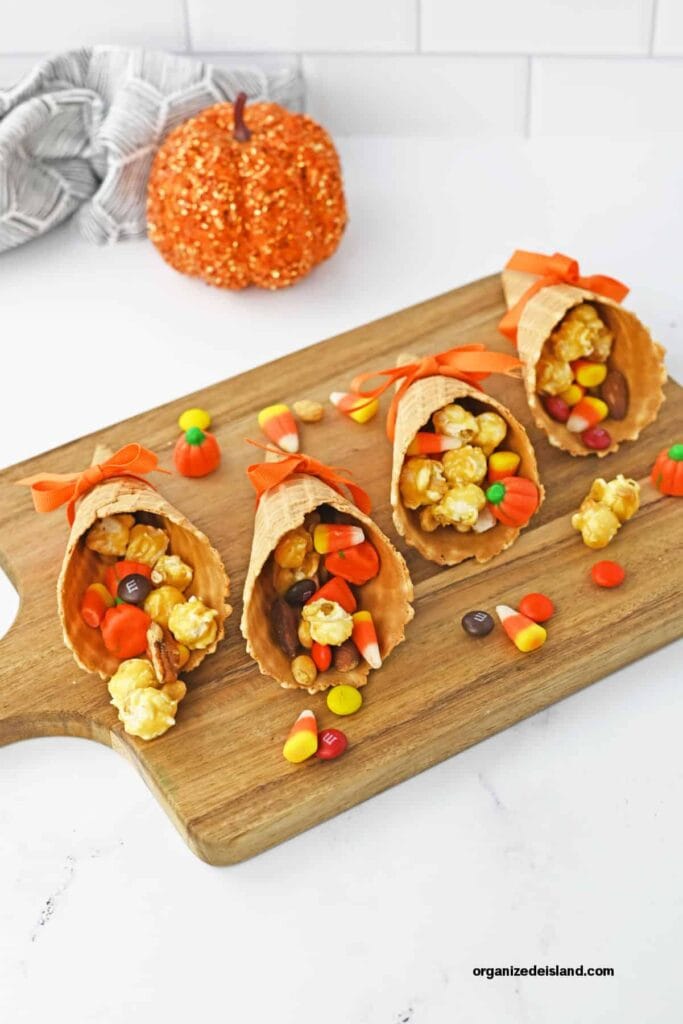 Candy cornucopias on a wooden board.