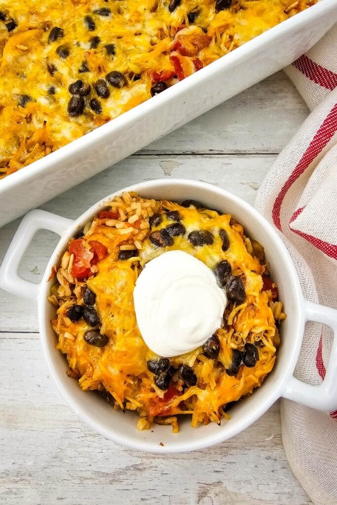 Chicken Taco Casserole in a bowl topped with sour cream.