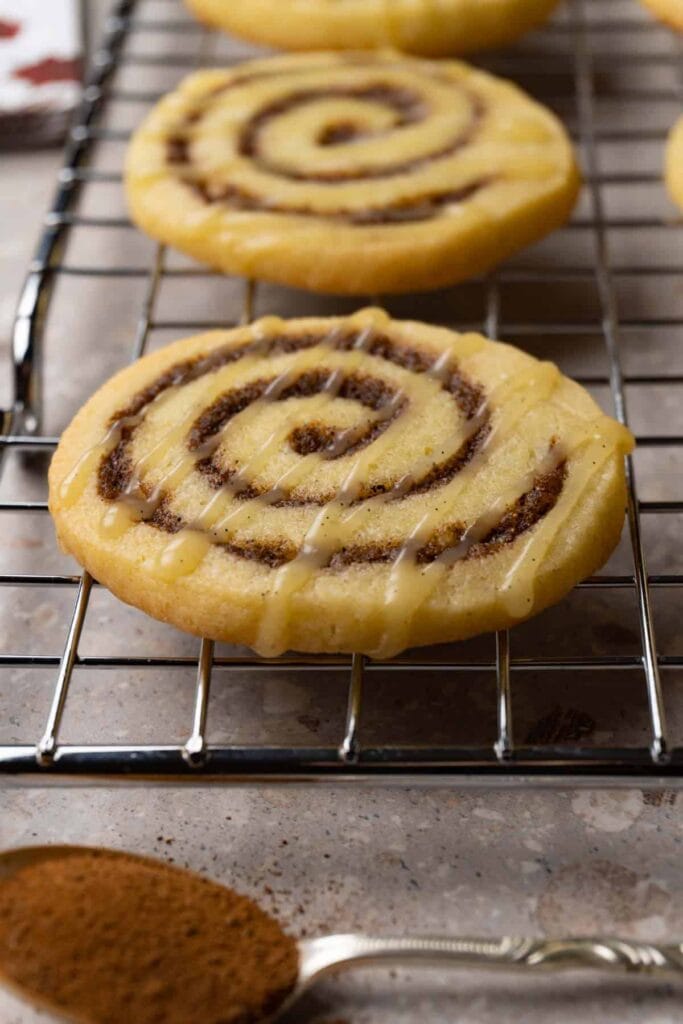 Cinnamon roll cookies on a cooling rack.