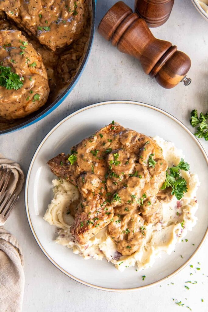 Cream of mushroom pork chops on a plate.
