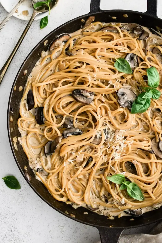 Creamy mushroom pasta in a skillet.
