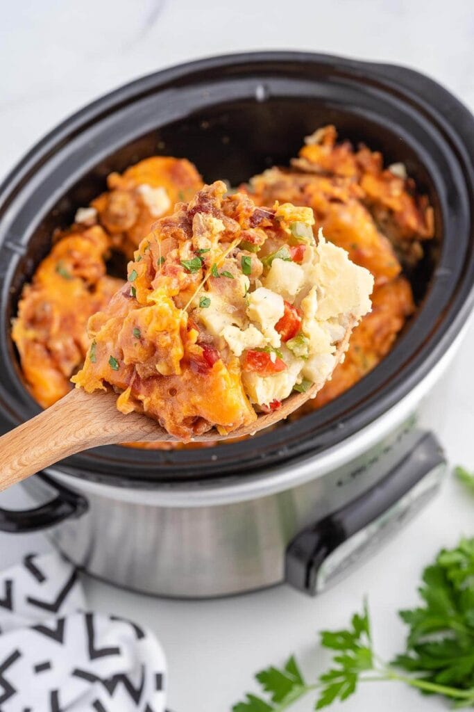 breakfast casserole being scooped out of slow cooker