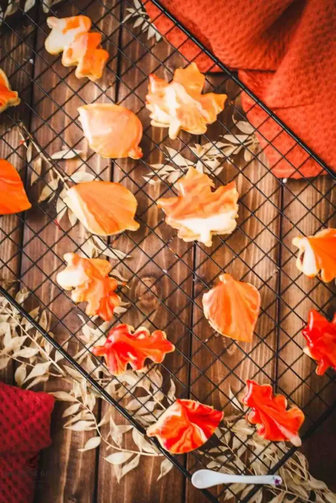 Fall sandwich cookies on a cooling rack.