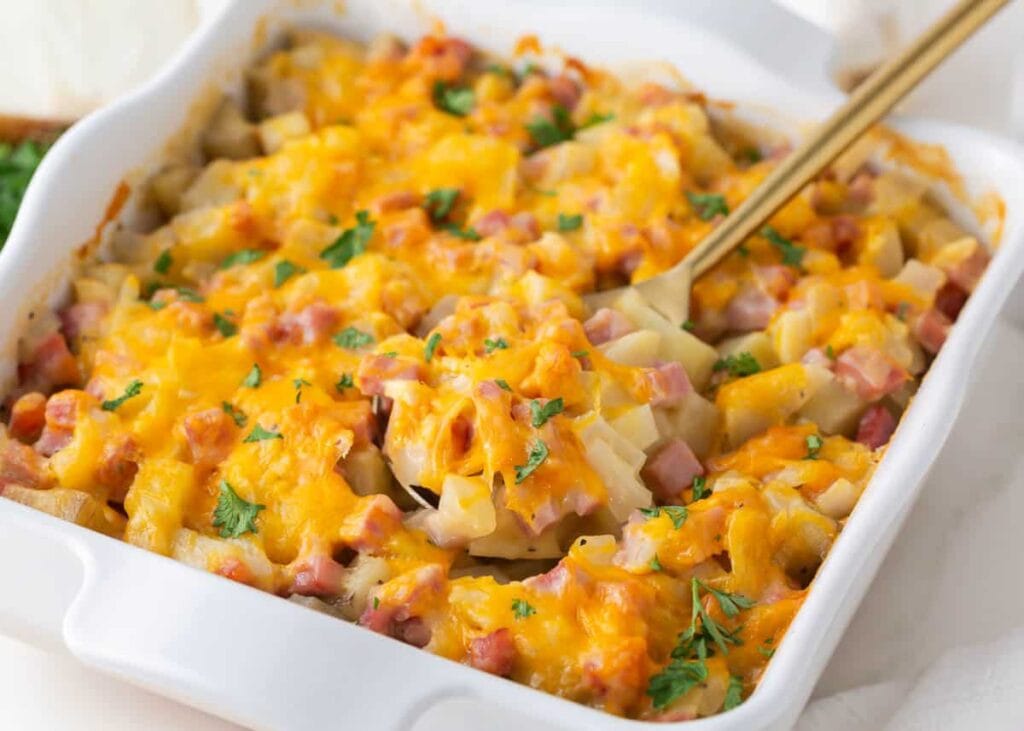Ham and Potato Casserole with cheese in a baking dish.