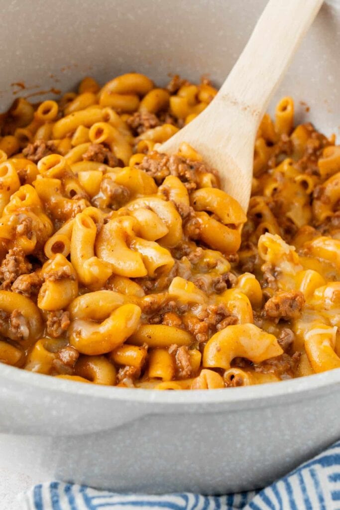 Cheesy hamburger helper with ground beef in a pot.