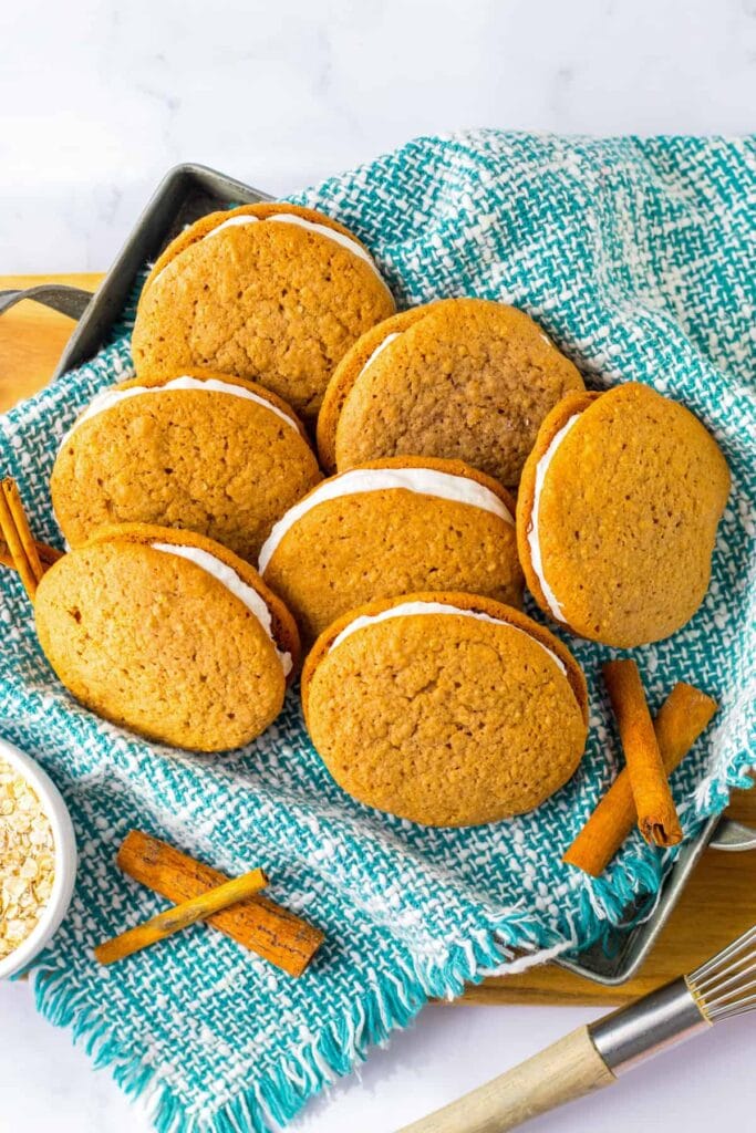 Homemade oatmeal cream pies on a baking tray.