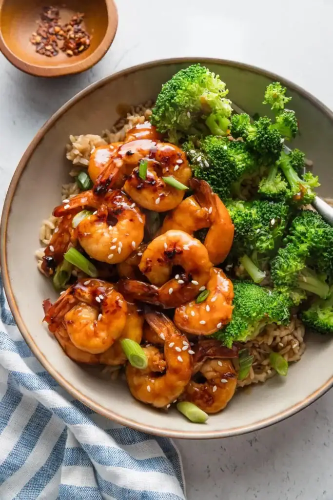 Honey garlic shrimp on a plate with broccoli.