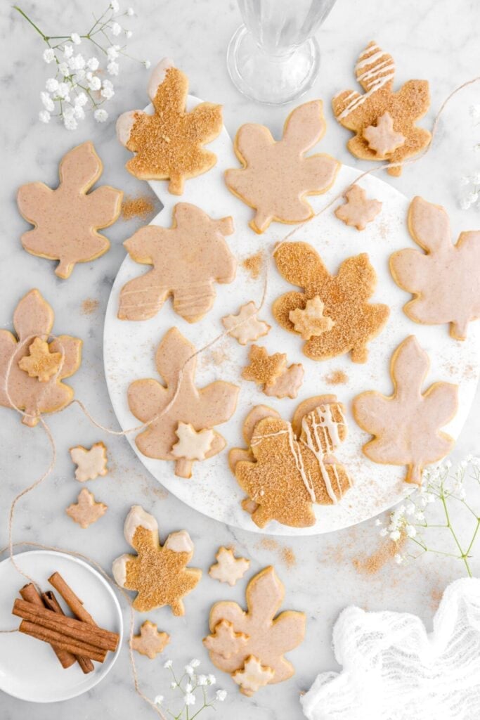 Iced maple cutout sugar cookies on a plate.