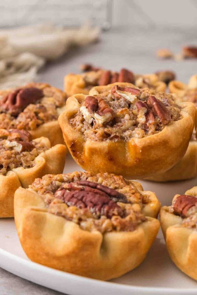 Mini pecan pies on a plate.