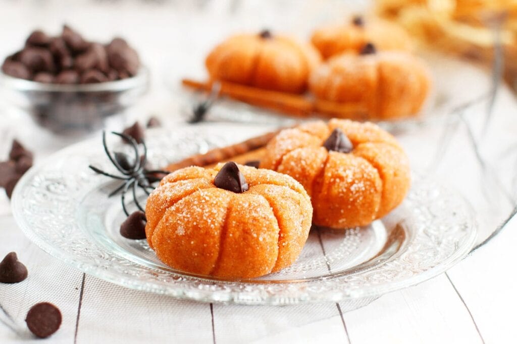 Pumpkin cheesecake truffles on a plate.