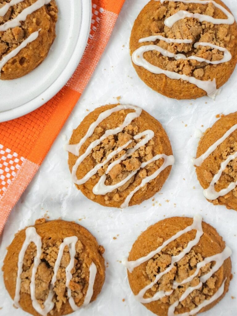 Pumpkin coffee cake cookies on parchment paper.