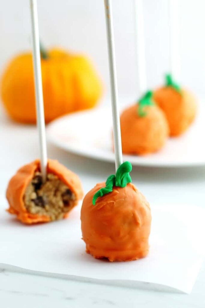 Pumpkin pops on a white surface.