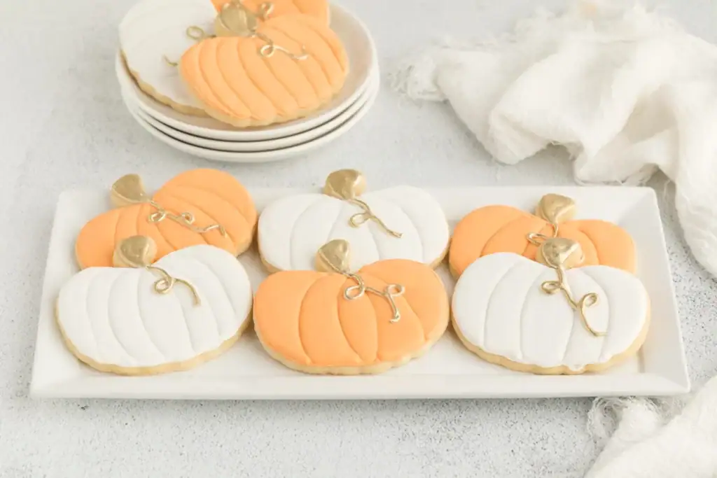 Pumpkin-shaped cookies on a plate.