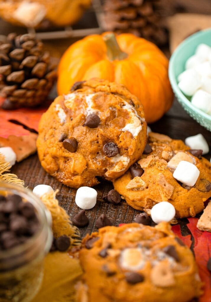 Pumpkin s'mores cookies on a rustic fall table.