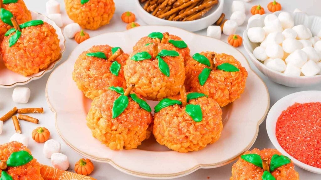 Rice krispie treat pumpkins on white plate