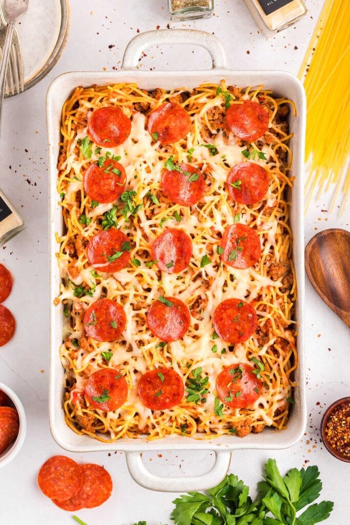 Overhead view of spaghetti pizza in a baking dish.