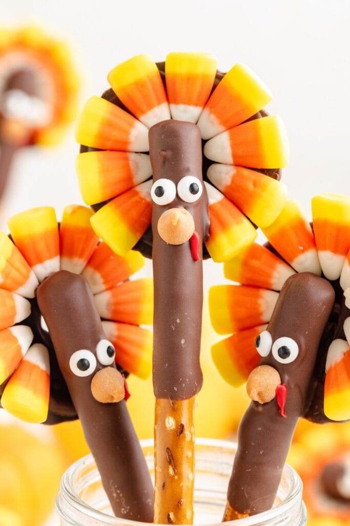 Thanksgiving turkey pretzel rods in a glass jar.
