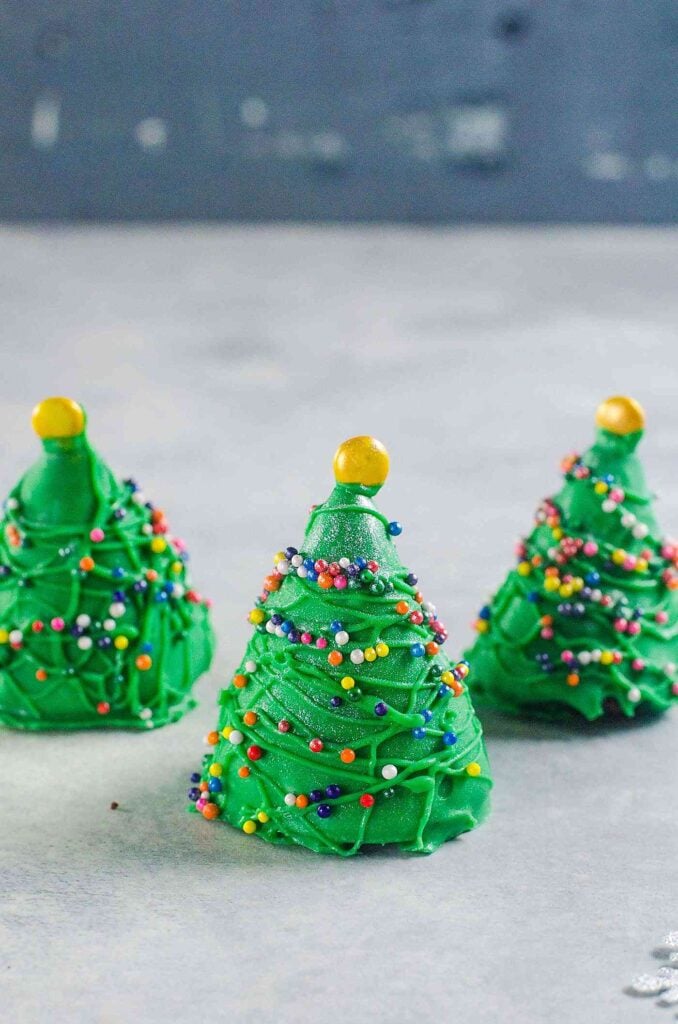 Christmas tree truffles on light grey and blue background