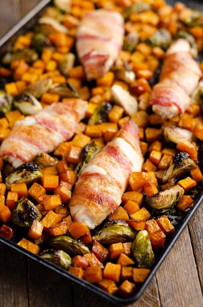 Bacon Wrapped Chicken & Balsamic Squash Sheet Pan Dinner in an overhead view.