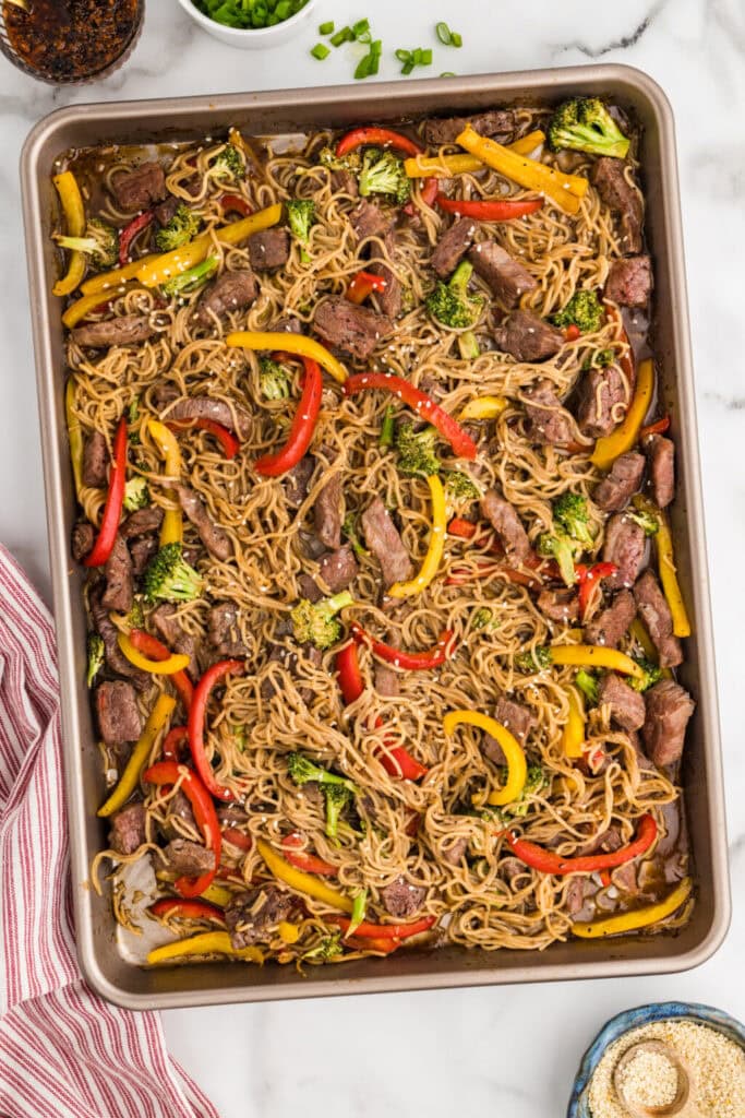 Beef and ramen noodles on a sheet pan.