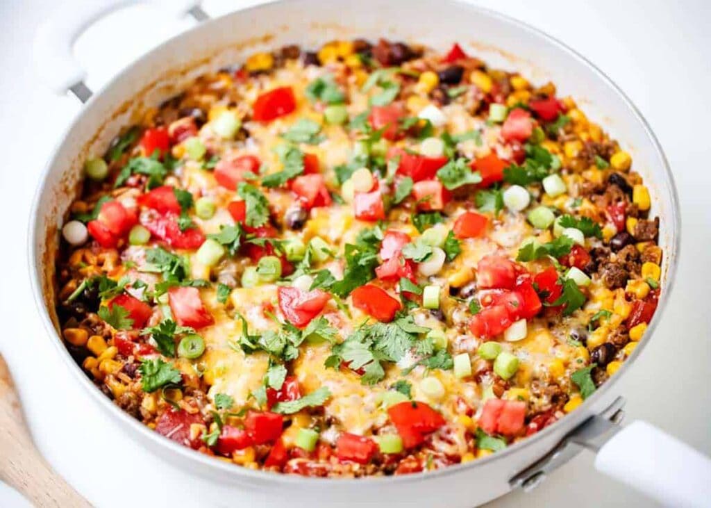 Overhead view of burrito bowls in a skillet.