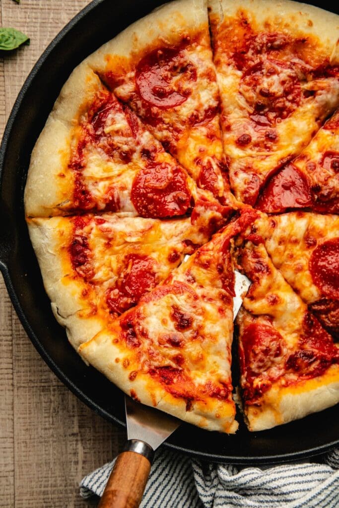 Cheesy pepperoni pizza in a cast iron skillet.