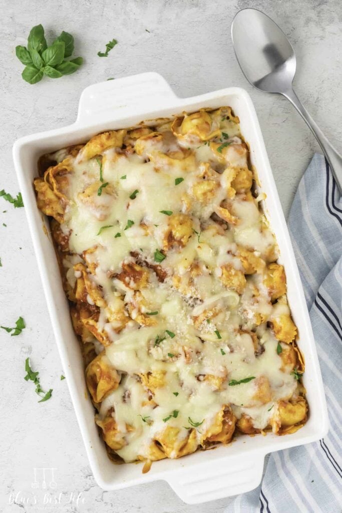 Cheesy baked tortellini casserole in a baking dish.