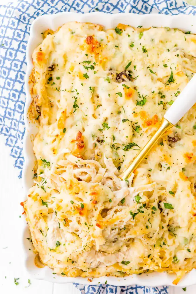 Chicken tetrazzini with melted cheese in a baking dish.