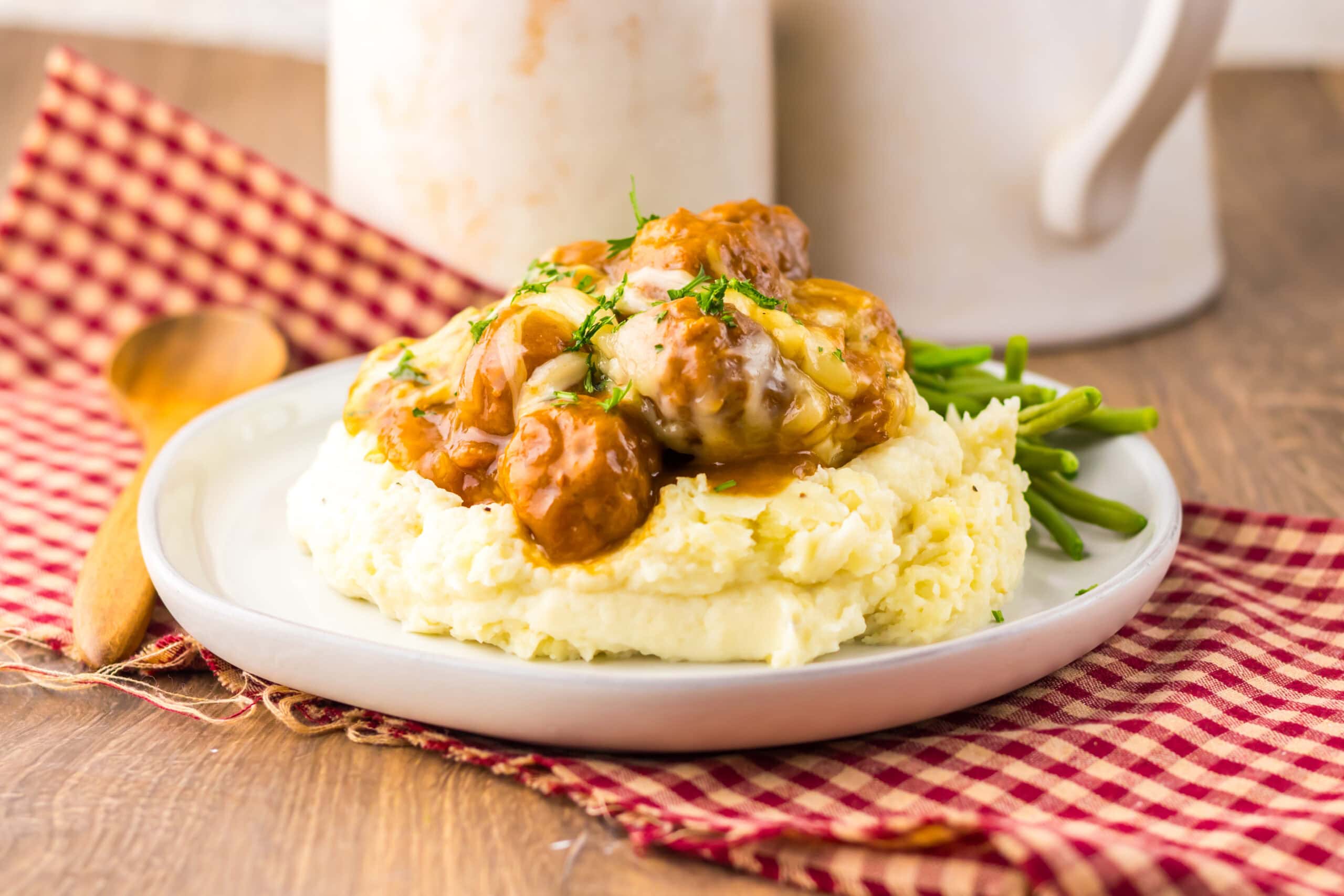 Close-up of French onion meatballs and mashed potatoes.